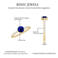 Rosec Jewels 5mm lab-created blue sapphire promise ring with diamond side stones, showcasing a sleek silver band and sparkling accents.