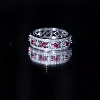 Yellow gold lab-grown ruby vintage wedding band ring with moissanite, featuring intricate detailing and sparkling gemstones.