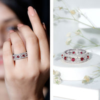 Lab grown ruby vintage wedding band ring with moissanite stones, featuring detailed metalwork and a classic design.