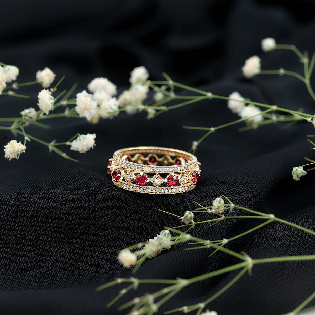Vintage lab-grown ruby wedding band ring with moissanite accents by Rosec Jewels, showcasing a detailed jewelry design.