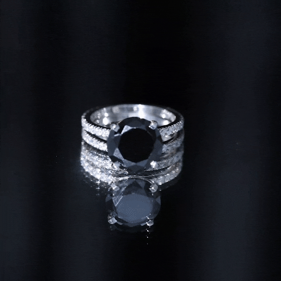 Black diamond engagement ring with 4.5 carats and moissanite wedding band, crafted by Rosec Jewels, displayed on a yellow background.