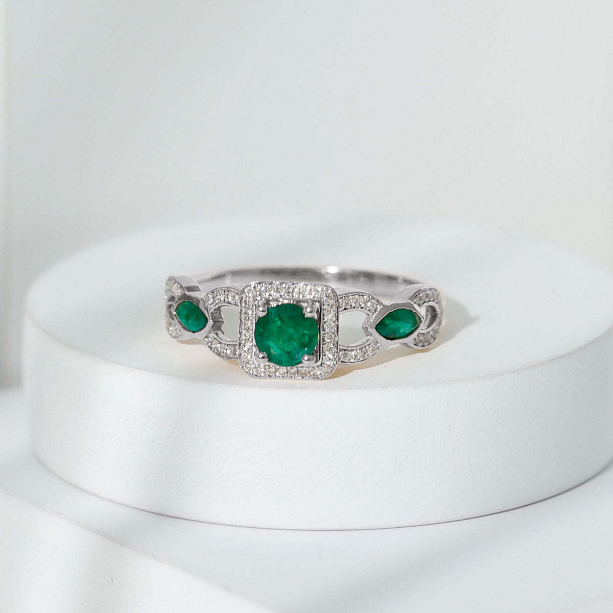 Vintage style emerald and diamond engagement ring for women by Rosec Jewels, featuring a central emerald surrounded by diamonds.