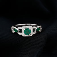 Vintage style emerald and diamond engagement ring for women by Rosec Jewels, featuring a central emerald surrounded by sparkling diamonds.