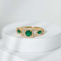 Vintage style emerald and diamond engagement ring for women, featuring intricate design and sparkling gemstones by Rosec Jewels.