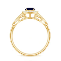Vintage-inspired blue sapphire engagement ring with diamond halo by Rosec Jewels, featuring a detailed ring setting and sparkling gemstones.