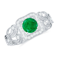 Vintage-looking emerald engagement ring with diamond halo from Rosec Jewels, showcasing intricate design and sparkling gemstones.