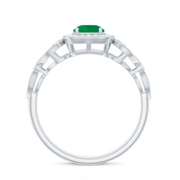Vintage emerald engagement ring with diamond halo from Rosec Jewels, featuring an intricate design and sparkling gemstones.