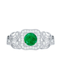 Vintage emerald engagement ring with diamond halo by Rosec Jewels, showcasing a detailed emerald gemstone and sparkling diamond accents.