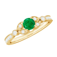 Vintage-inspired engagement ring featuring a natural emerald and diamond accents, crafted by Rosec Jewels.