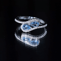 Genuine aquamarine two-stone engagement ring with diamonds by Rosec Jewels, featuring a white gold band and sparkling gemstones.