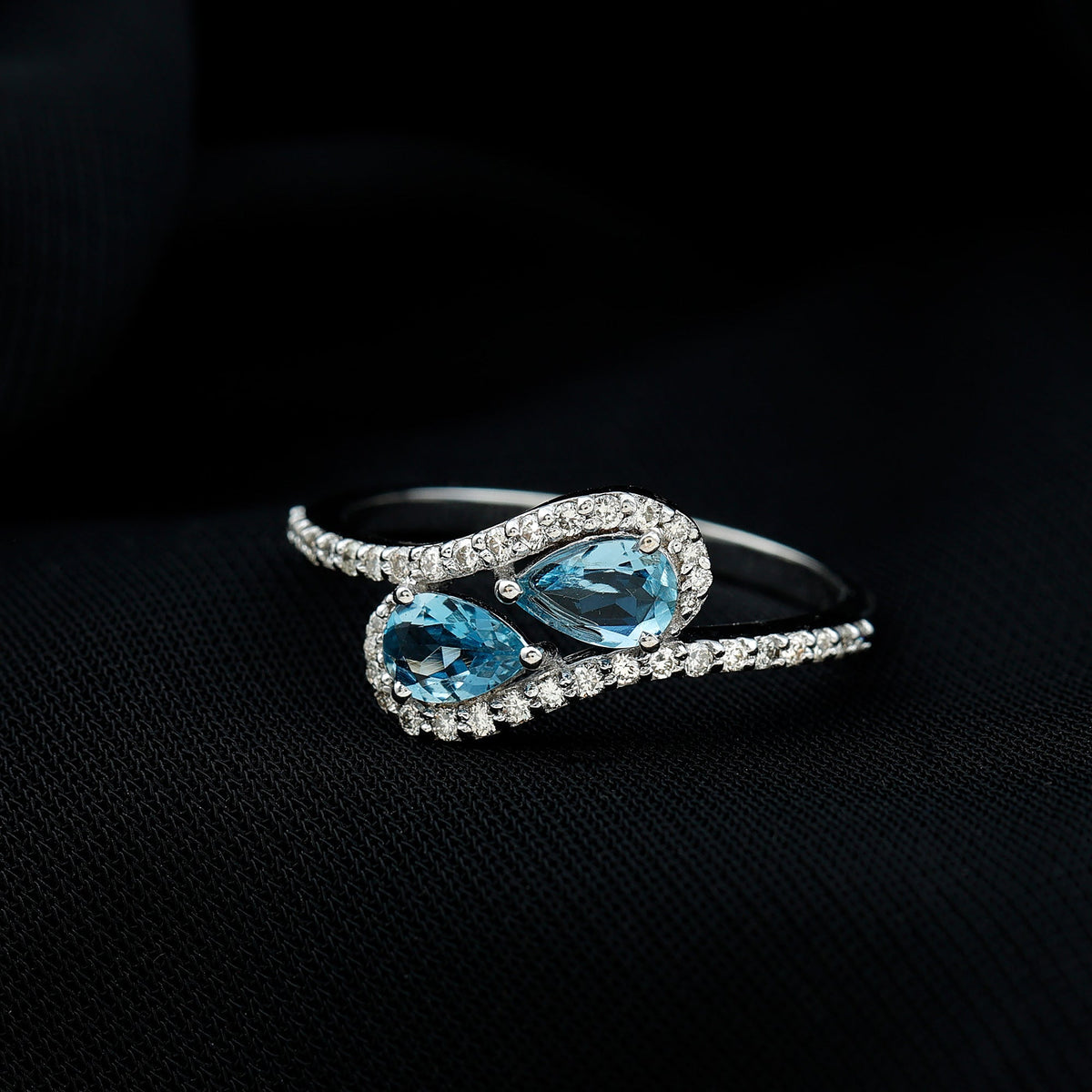 Genuine aquamarine two-stone engagement ring with diamonds, featuring a rose gold band and intricate detailing.