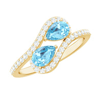Genuine aquamarine two-stone engagement ring with diamond accents, featuring a silver band and intricate detailing.