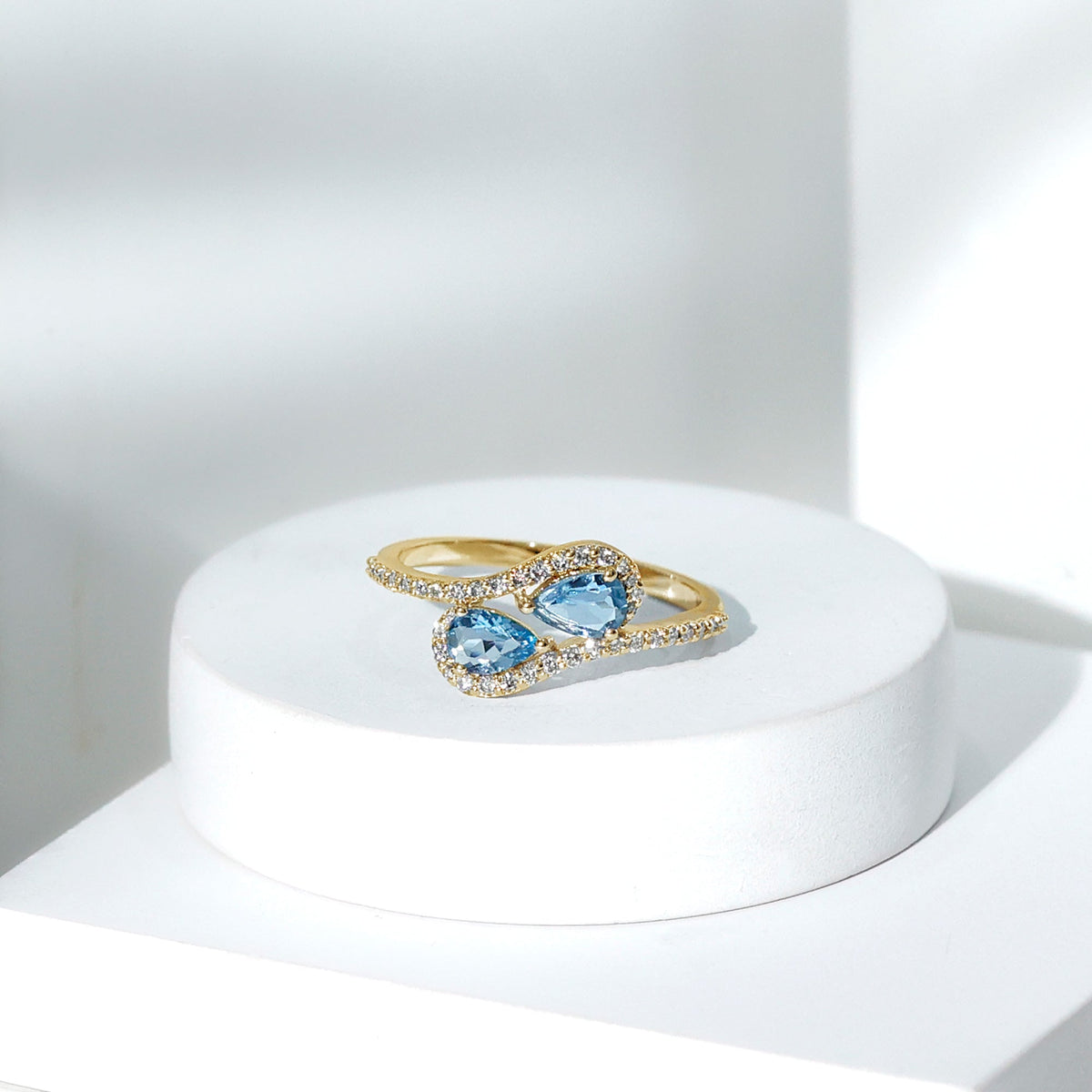 Genuine aquamarine two-stone engagement ring with diamonds, showcasing a elegant rose gold band and detailed craftsmanship.
