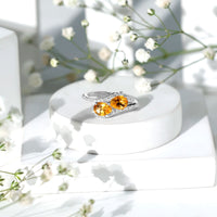 Pear-shaped citrine two-stone engagement ring with diamond accents by Rosec Jewels, featuring a gold band and elegant design.