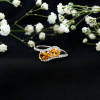Pear-shaped citrine two-stone engagement ring with diamond accents, featuring gold band and Rosec Jewels branding.