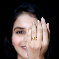 Pear-shaped citrine and diamond engagement ring with two stones, set in a rose gold band by Rosec Jewels.