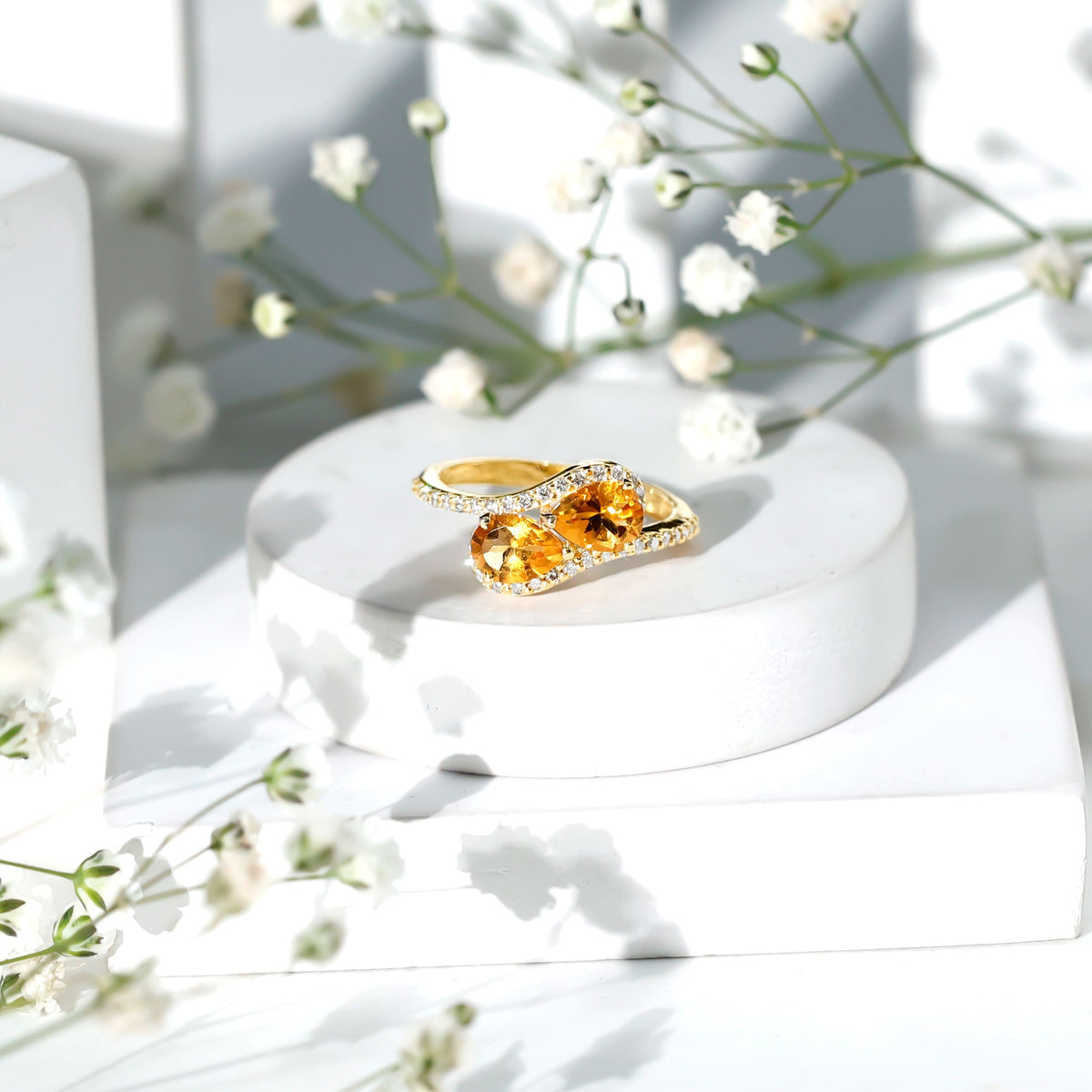 Pear shape citrine two-stone engagement ring with diamond accents, set in a rose gold band, by Rosec Jewels.