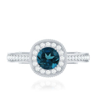 Vintage London Blue Topaz engagement ring with diamond halo, featuring intricate metalwork and elegant design by Rosec Jewels.
