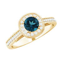 Vintage London Blue Topaz engagement ring with diamond halo, featuring intricate setting and sparkling blue gemstone from Rosec Jewels.