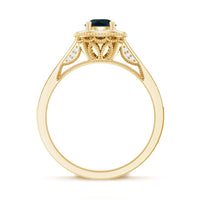 Vintage London Blue Topaz engagement ring with diamond halo, showcasing intricate design and sparkling stones.