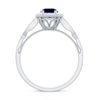 Round 0.9 carat blue sapphire antique engagement ring with diamond halo, featuring intricate vintage-style design.