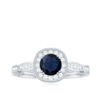 Round 0.9 carat blue sapphire antique engagement ring with diamond halo, featuring intricate vintage-style design and sterling band.