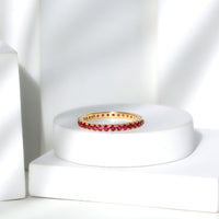 Rosec Jewels French pave set lab-grown ruby stackable eternity ring with sparkling ruby accents and a sleek gold band.
