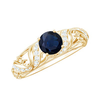 Vintage-looking engagement ring with a 0.9 carat blue sapphire and diamond accents, featuring intricate metalwork, by Rosec Jewels.