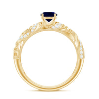 Vintage-style engagement ring featuring a 0.9 carat blue sapphire centerpiece surrounded by diamonds, crafted by Rosec Jewels.