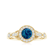 London Blue Topaz antique engagement ring with diamond halo, showcasing a 0.6 carat central gemstone and intricate design.