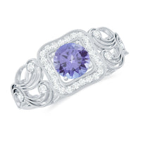 Vintage-style tanzanite engagement ring with diamond halo from Rosec Jewels featuring intricate metalwork and sparkling gemstones.