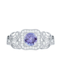 Vintage-style Tanzanite engagement ring with diamond halo from Rosec Jewels, featuring a central blue-purple tanzanite gemstone and sparkling accents.