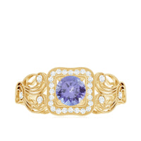 Rosec Jewels vintage tanzanite engagement ring with diamond halo, featuring intricate metalwork and a central purple-blue gemstone.