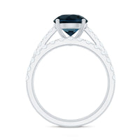 Two rose gold London Blue Topaz solitaire rings with Moissanite bands, featuring round cut gemstones in an elegant jewelry set.