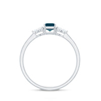 Emerald cut London Blue Topaz engagement ring by Rosec Jewels featuring a diamond trio setting and intricate band details.