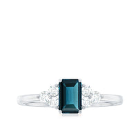 Emerald cut London Blue Topaz engagement ring with diamond trio accents, crafted by Rosec Jewels, showcasing elegant jewelry design.