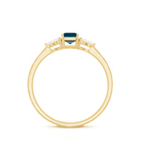 Emerald cut London Blue Topaz engagement ring with diamond trio accents by Rosec Jewels, showcasing a silver band and elegant design.