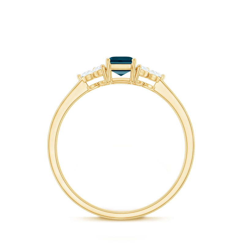 Emerald cut London Blue Topaz engagement ring with diamond trio accents by Rosec Jewels, showcasing a silver band and elegant design.