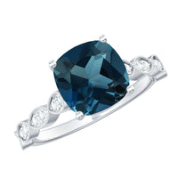 Rosec Jewels cushion cut London Blue Topaz vintage engagement ring with diamond accents, showcasing intricate metalwork and gemstone setting.
