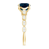 Vintage engagement ring featuring a cushion cut London Blue Topaz with surrounding diamonds, crafted by Rosec Jewels.