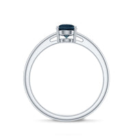 Pear-shaped London Blue Topaz solitaire ring by Rosec Jewels, showcasing the elegant gemstone setting in a close-up view.