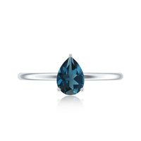 Pear-shaped London Blue Topaz solitaire ring with a silver band, featuring a vibrant 5x7mm gemstone.