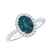 Oval cut London Blue Topaz engagement ring with diamond halo, featuring a classic design by Rosec Jewels.