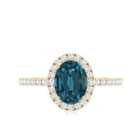 Oval cut London Blue Topaz engagement ring with diamond halo by Rosec Jewels, showcasing the elegant gemstone and intricate design.