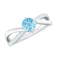Genuine aquamarine engagement ring with diamond infinity shank from Rosec Jewels, featuring a central blue aquamarine gemstone and diamond accents.