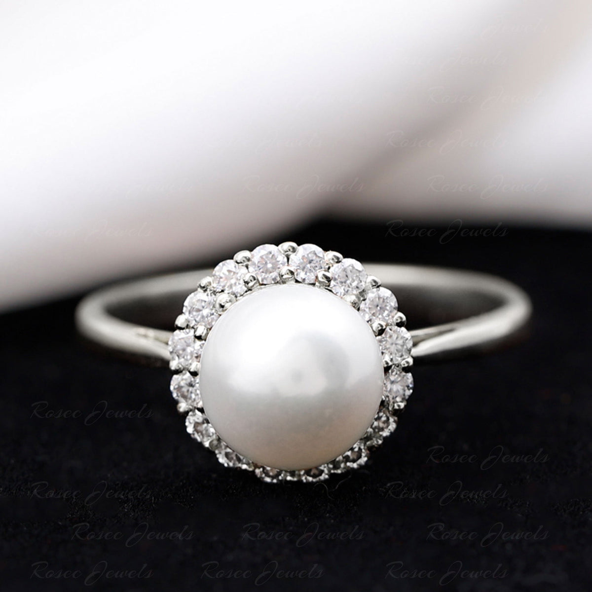 Rosec Jewels 7.4 carat freshwater pearl engagement ring with diamond halo, showcasing a elegant pearl centerpiece and sparkling accents.
