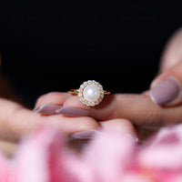 Freshwater pearl engagement ring with diamond halo from Rosec Jewels, showcasing a 7.4-carat pearl and sparkling diamond accents.
