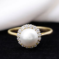 Rosec Jewels freshwater pearl engagement ring with 7.4 carats and diamond halo, featuring a elegant design with white pearls and sparkling diamonds.