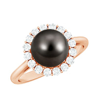 Natural Tahitian pearl and diamond halo engagement ring featuring a central pearl with surrounding sparkling diamonds.