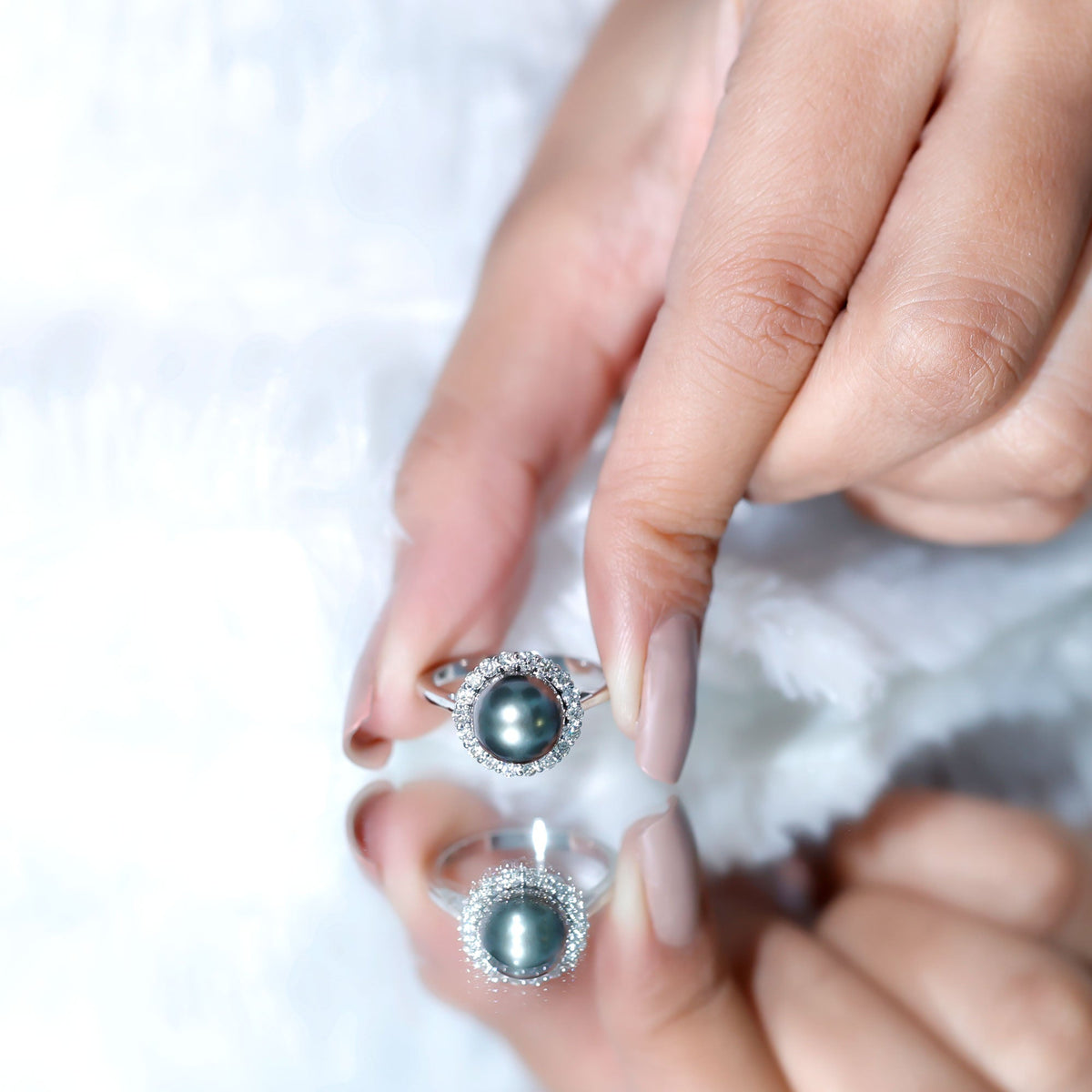 Natural Tahitian pearl and diamond halo engagement ring from Rosec Jewels, showcasing a lustrous black pearl surrounded by sparkling diamonds.